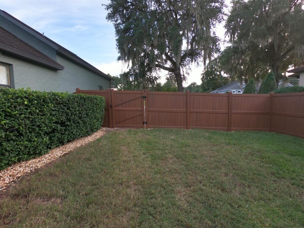 Vinyl Fence designed to look like wood fence. installed in ocala florida